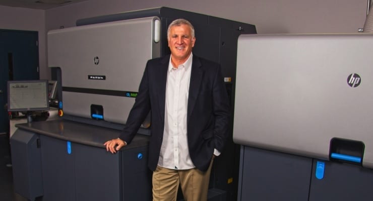 John Palica standing next to the new HP Indigo 6900 Digital Press